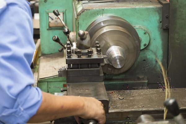 operator turning precision mold parts by manual lathe